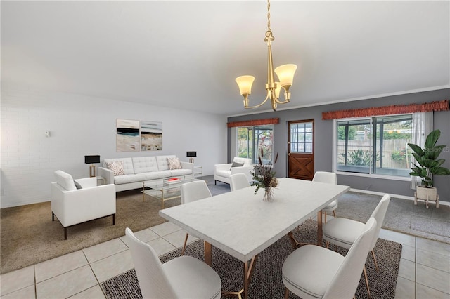 dining space with light tile patterned flooring and an inviting chandelier