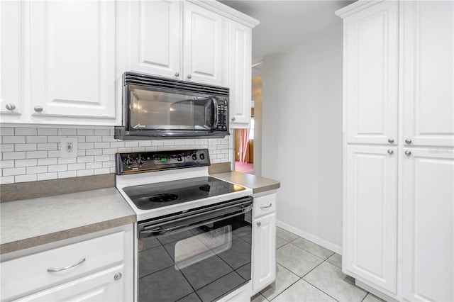 kitchen with white cabinetry, range with electric cooktop, light tile patterned floors, and decorative backsplash