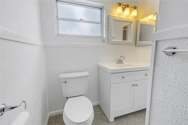 bathroom with vanity, tile patterned flooring, and toilet