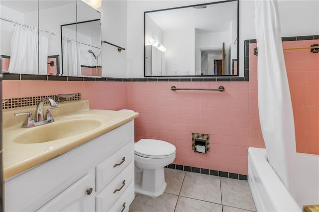 full bathroom with tile walls, tile patterned flooring, vanity, toilet, and shower / bath combo with shower curtain