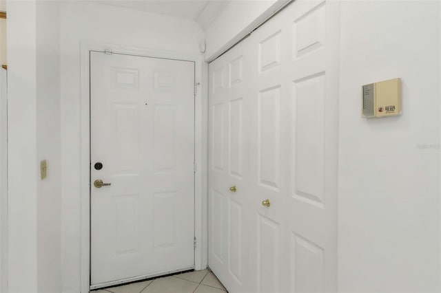 doorway featuring light tile patterned flooring