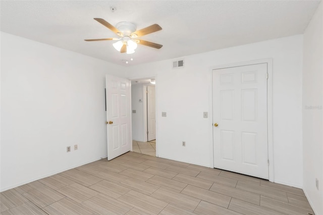 unfurnished bedroom featuring ceiling fan