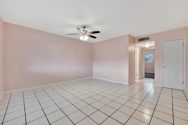 empty room featuring ceiling fan and light tile patterned floors