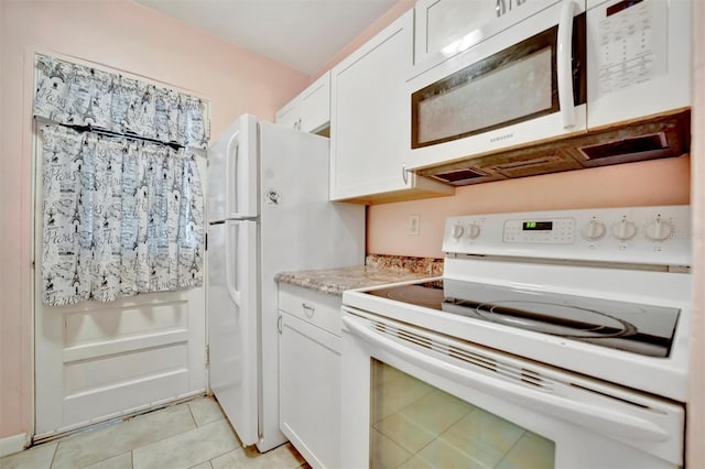 kitchen with light tile patterned floors, white appliances, and white cabinets