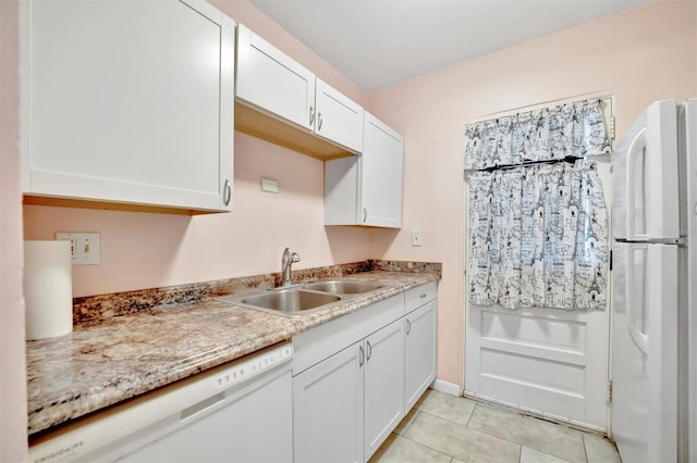 kitchen with white cabinetry, sink, white appliances, and light stone counters