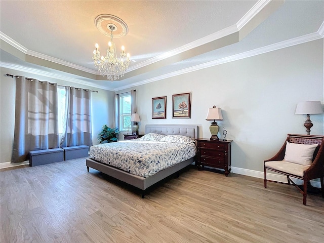 bedroom featuring a notable chandelier, wood-type flooring, ornamental molding, and a raised ceiling