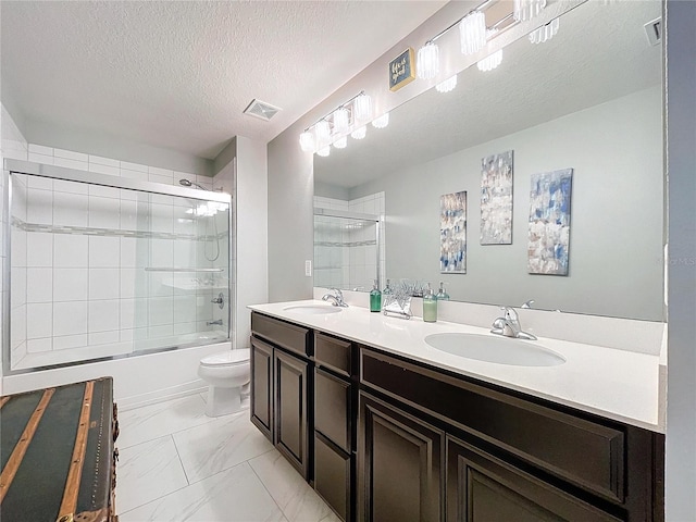 full bathroom with shower / bath combination with glass door, vanity, toilet, and a textured ceiling