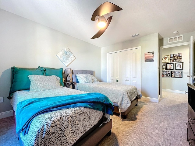 bedroom with carpet flooring, ceiling fan, and a closet