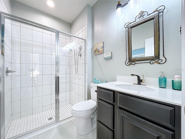 bathroom with walk in shower, vanity, and toilet