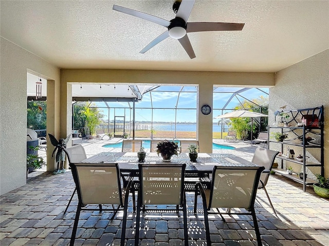 view of patio / terrace featuring ceiling fan and a lanai