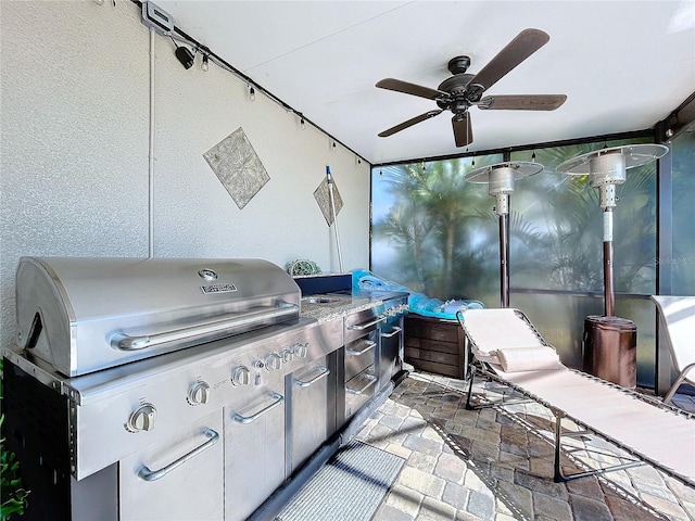 view of patio featuring grilling area, ceiling fan, and exterior kitchen