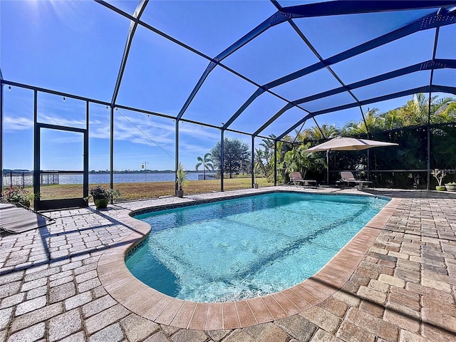 view of pool with a water view, a patio area, and glass enclosure