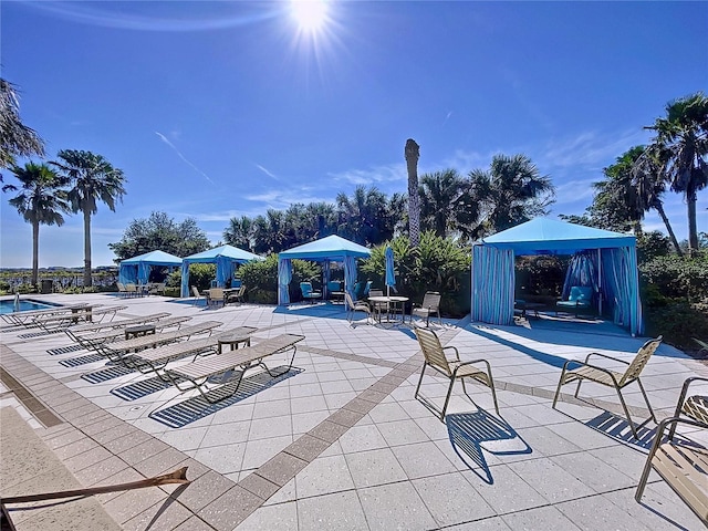 view of swimming pool with a gazebo and a patio area