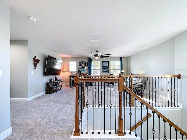 interior space featuring carpet floors and ceiling fan