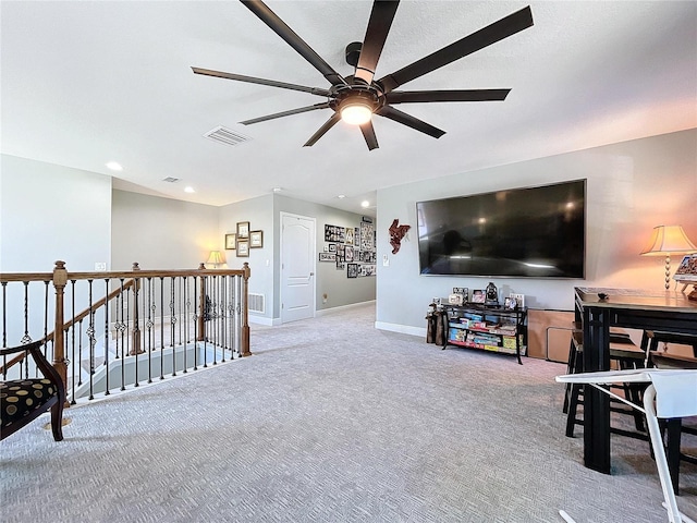 carpeted living room with ceiling fan