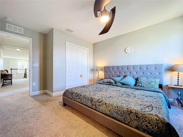 carpeted bedroom featuring ceiling fan and a closet