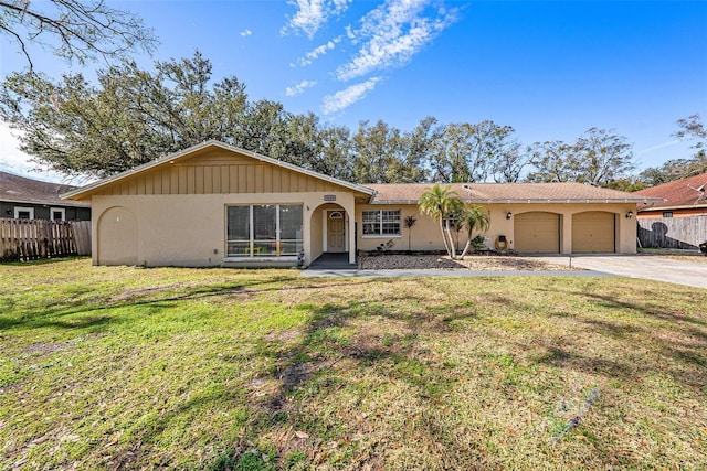 single story home with a garage and a front yard