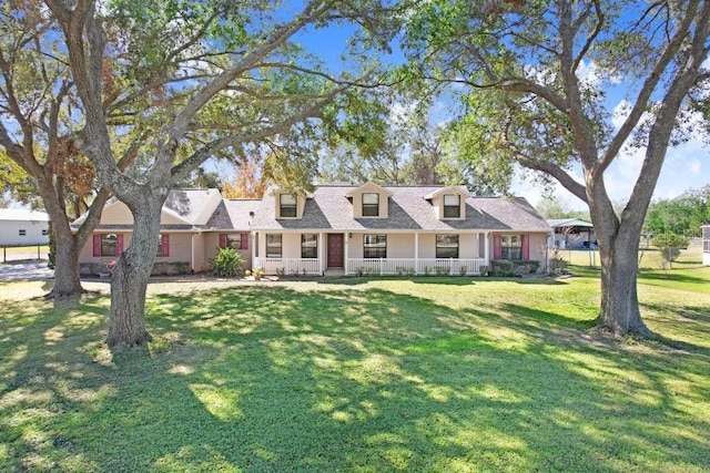 cape cod home with a front yard