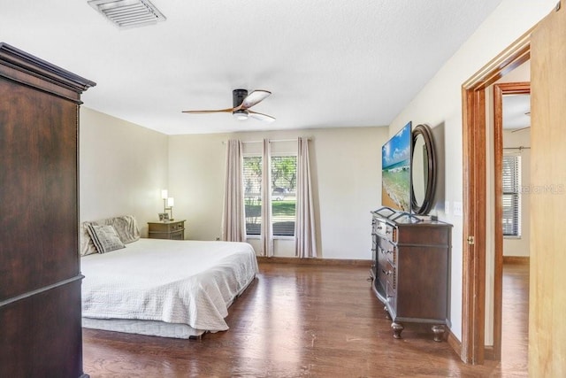 bedroom with dark wood-type flooring and ceiling fan