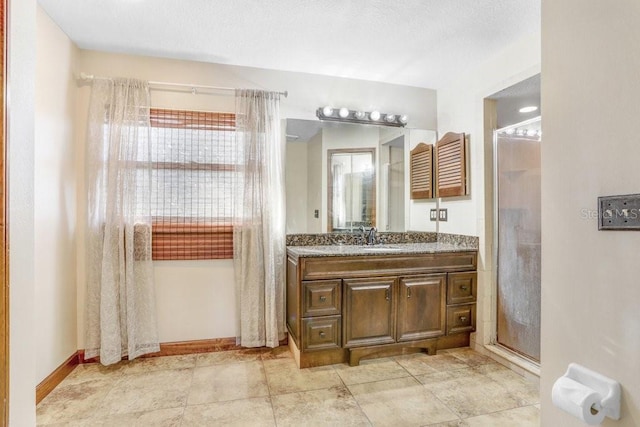 bathroom featuring vanity and an enclosed shower