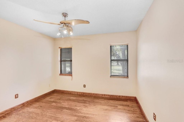 unfurnished room featuring ceiling fan and hardwood / wood-style floors