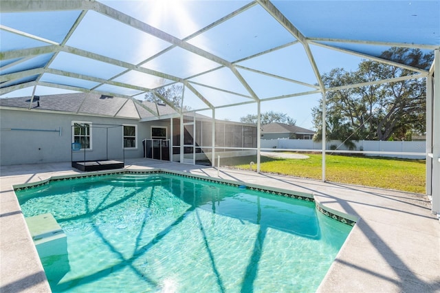 view of pool featuring a lanai, a patio area, and a lawn