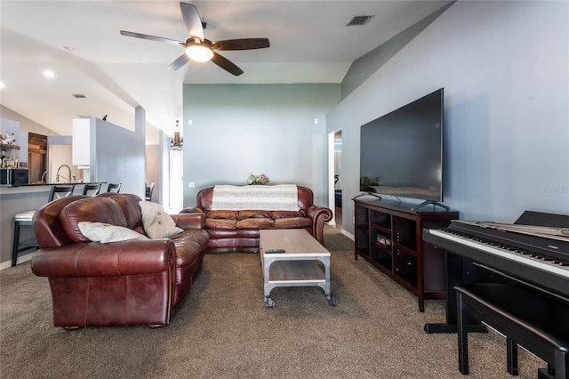 carpeted living room with ceiling fan and lofted ceiling