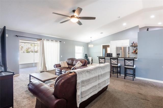 carpeted living room with lofted ceiling and ceiling fan