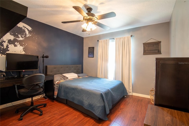 bedroom featuring ceiling fan and dark hardwood / wood-style flooring