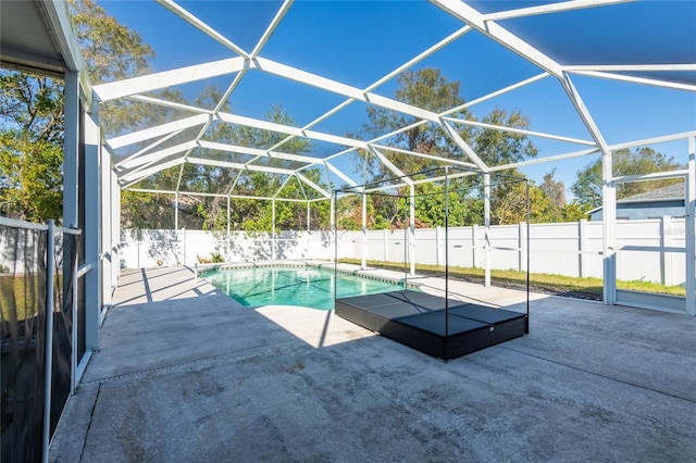 view of pool featuring a patio and glass enclosure