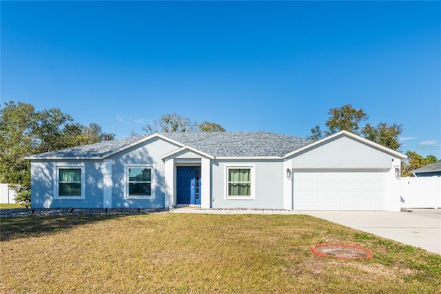 ranch-style house with a garage and a front lawn