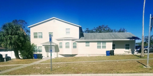 rear view of property featuring a yard