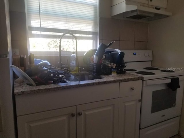 kitchen with white cabinetry, white electric range, and stone countertops