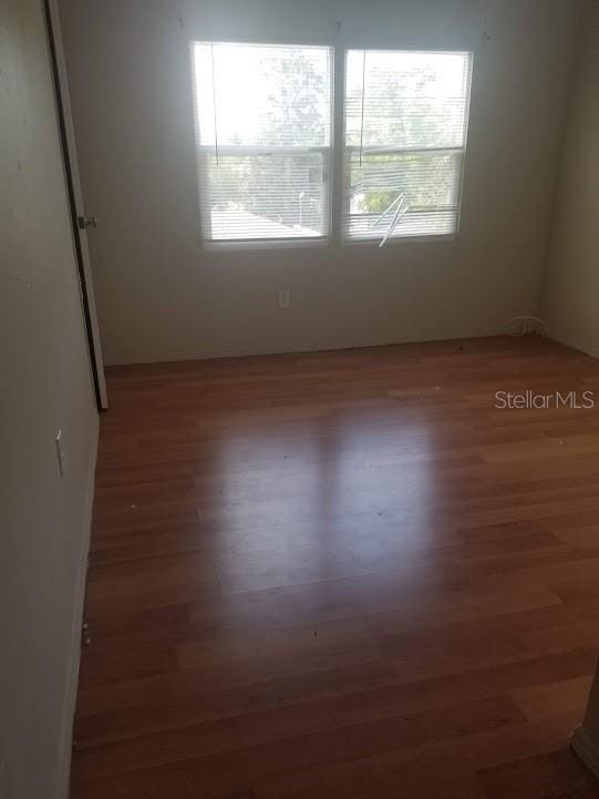 unfurnished room featuring dark hardwood / wood-style flooring