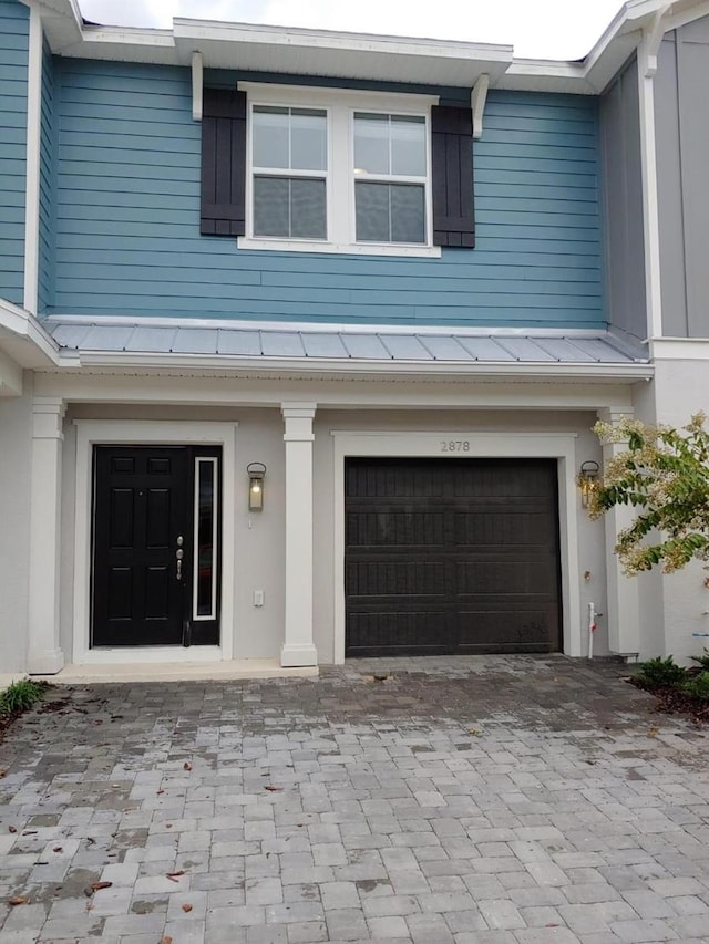 doorway to property with a garage