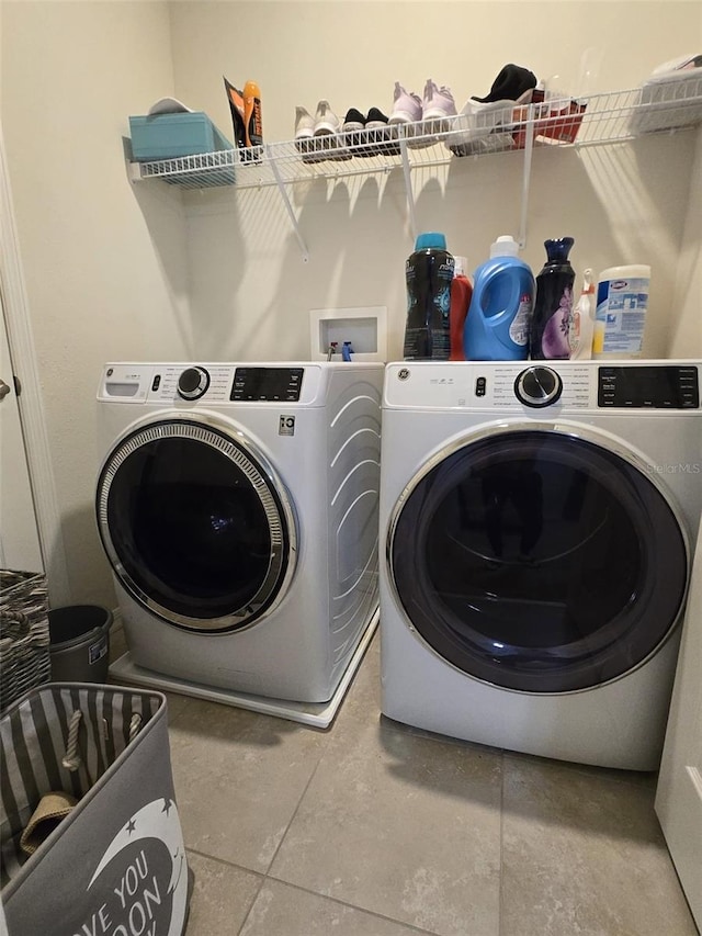 2878 Grand Kemerton Pl, Tampa, FL 33618 - laundry room with separate washer and dryer and tile patterned flooring