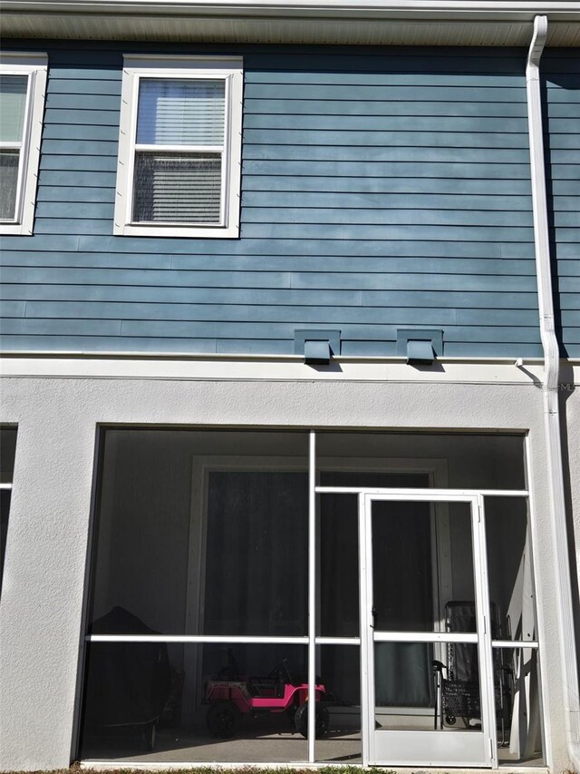 2878 Grand Kemerton Pl, Tampa, FL 33618 - view of property exterior with a sunroom