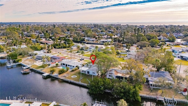 aerial view at dusk featuring a water view