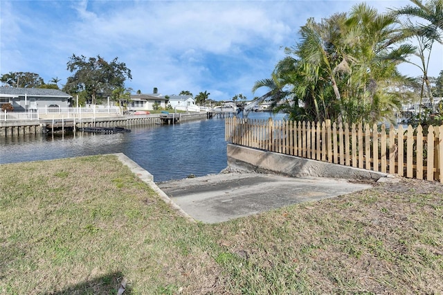 dock area featuring a lawn and a water view