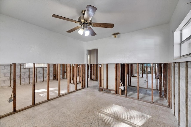 interior space with ceiling fan