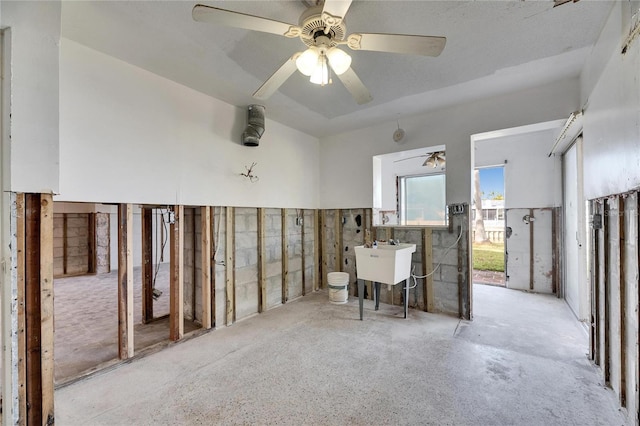 interior space featuring ceiling fan and sink