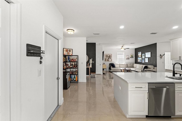 kitchen featuring sink, stainless steel dishwasher, white cabinets, and ceiling fan