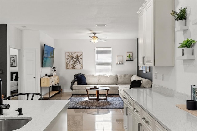 living room with sink and ceiling fan