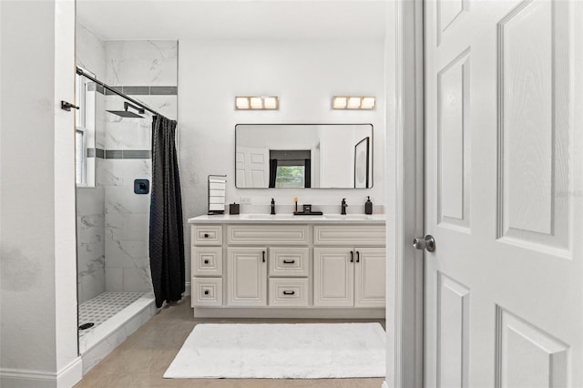 bathroom featuring vanity, tiled shower, and tile patterned floors