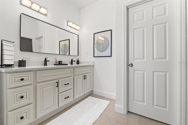 bathroom with tile patterned flooring and vanity