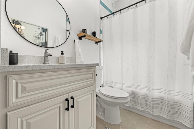 bathroom featuring tile patterned flooring, vanity, and toilet