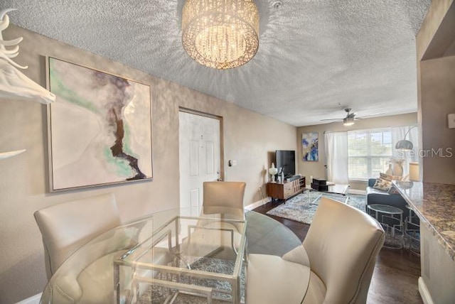 living room featuring wood-type flooring and ceiling fan with notable chandelier