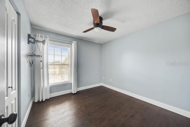 unfurnished room featuring dark hardwood / wood-style floors, a textured ceiling, and ceiling fan