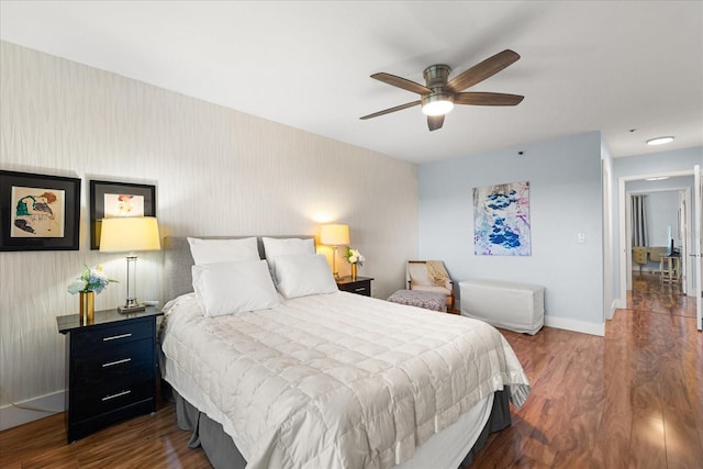 bedroom with dark wood-type flooring and ceiling fan