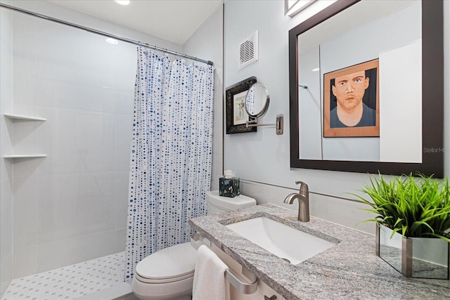 bathroom featuring vanity, toilet, and a shower with shower curtain